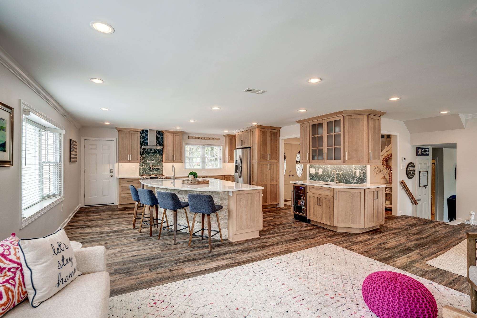 Light brown cabinetry in kitchen with dark, two-toned hard wood floors