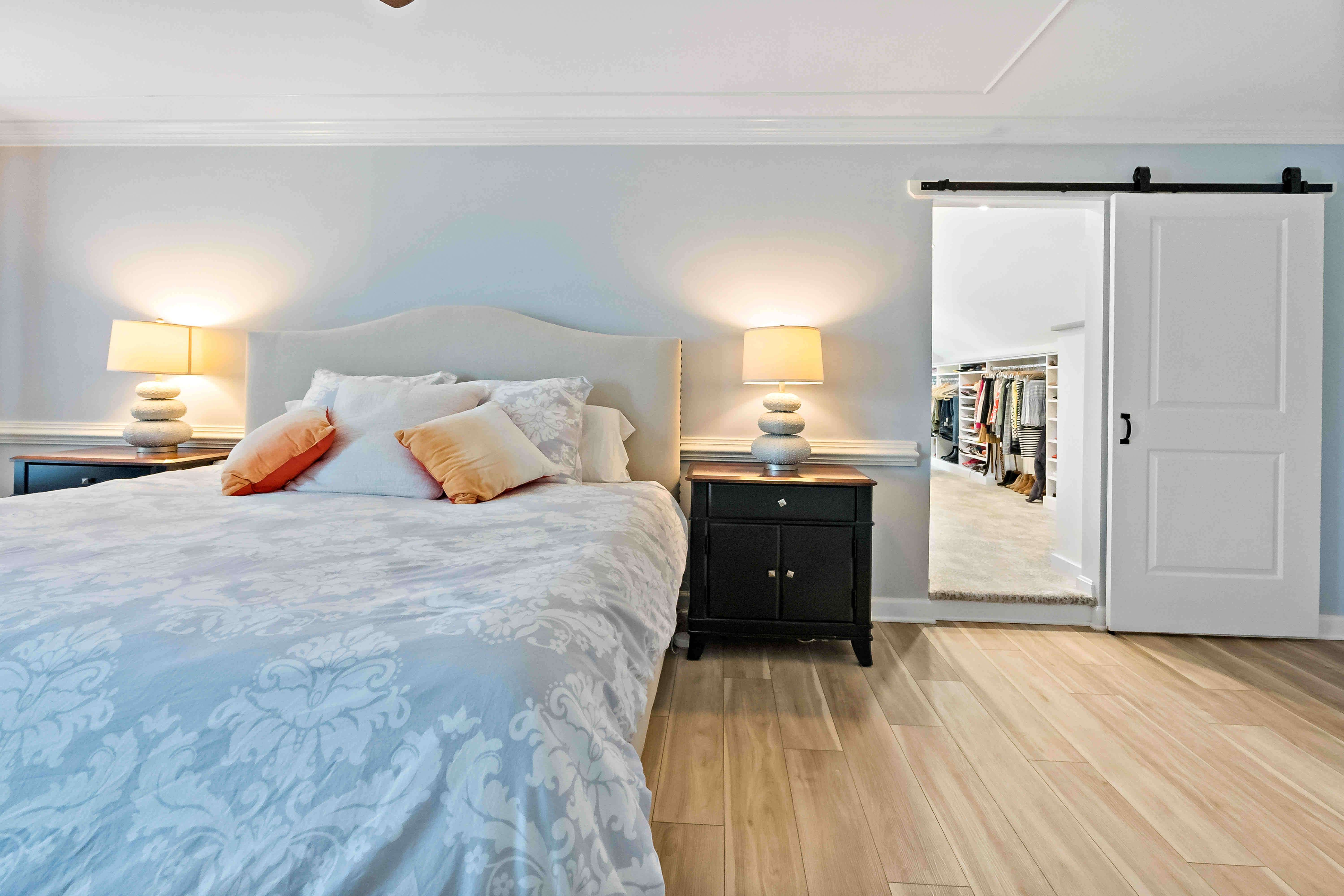 Master bedroom with sliding barn door to access the walk-in closet