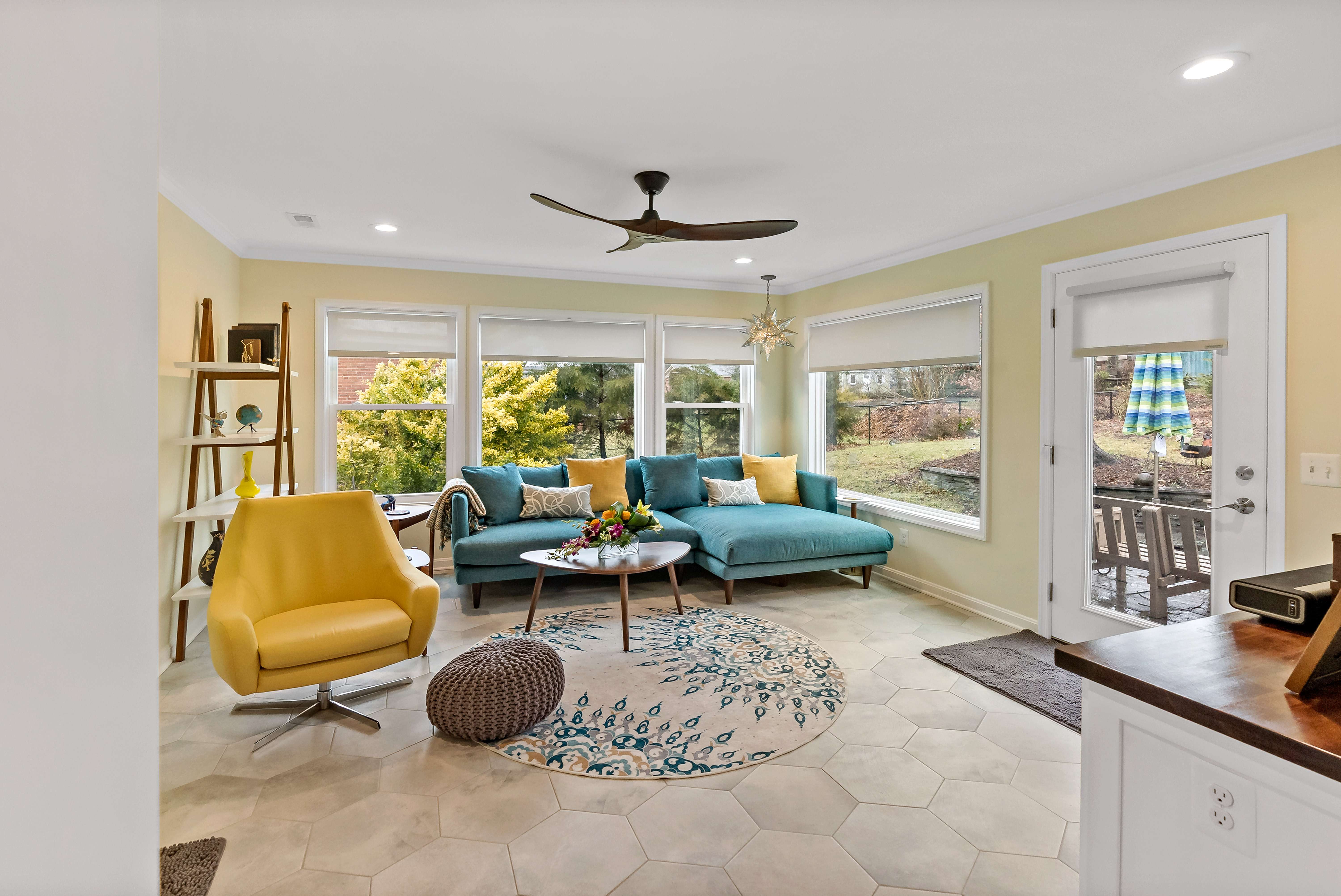 Colorful living space with large windows to enjoy backyard view
