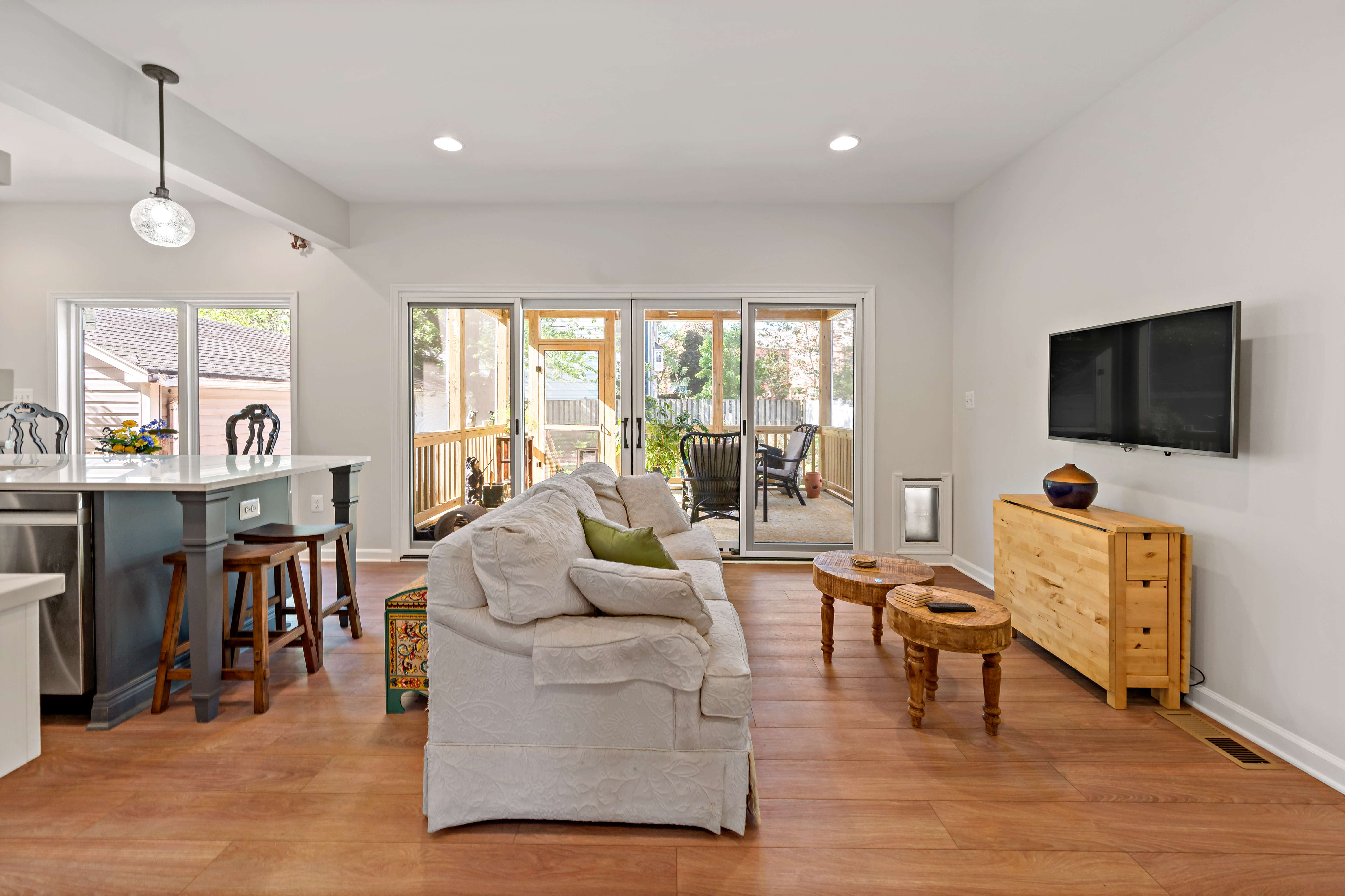 Open concept kitchen and living room with double door access to patio