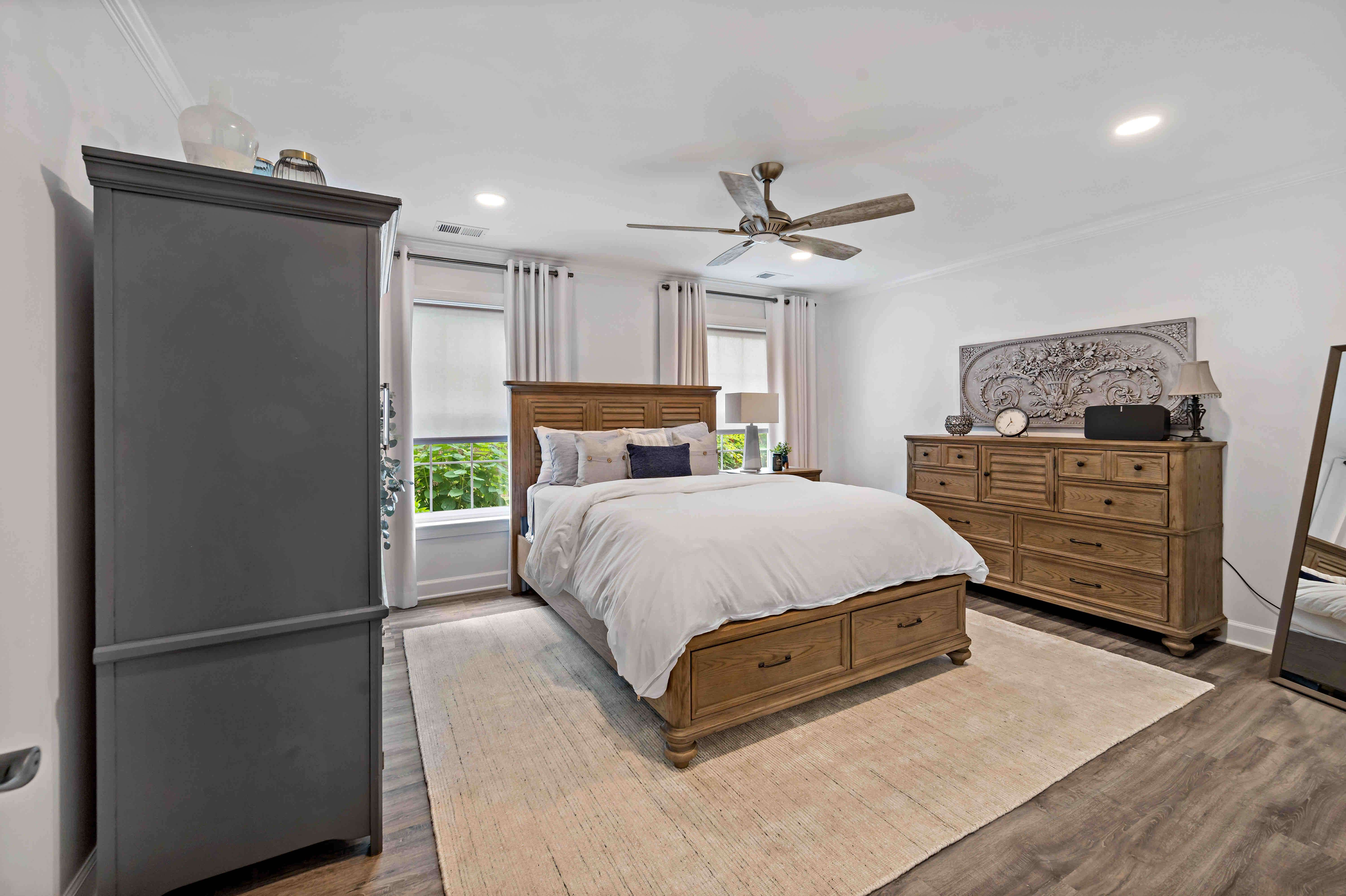 Large master bathroom with tall ceilings and window curtains