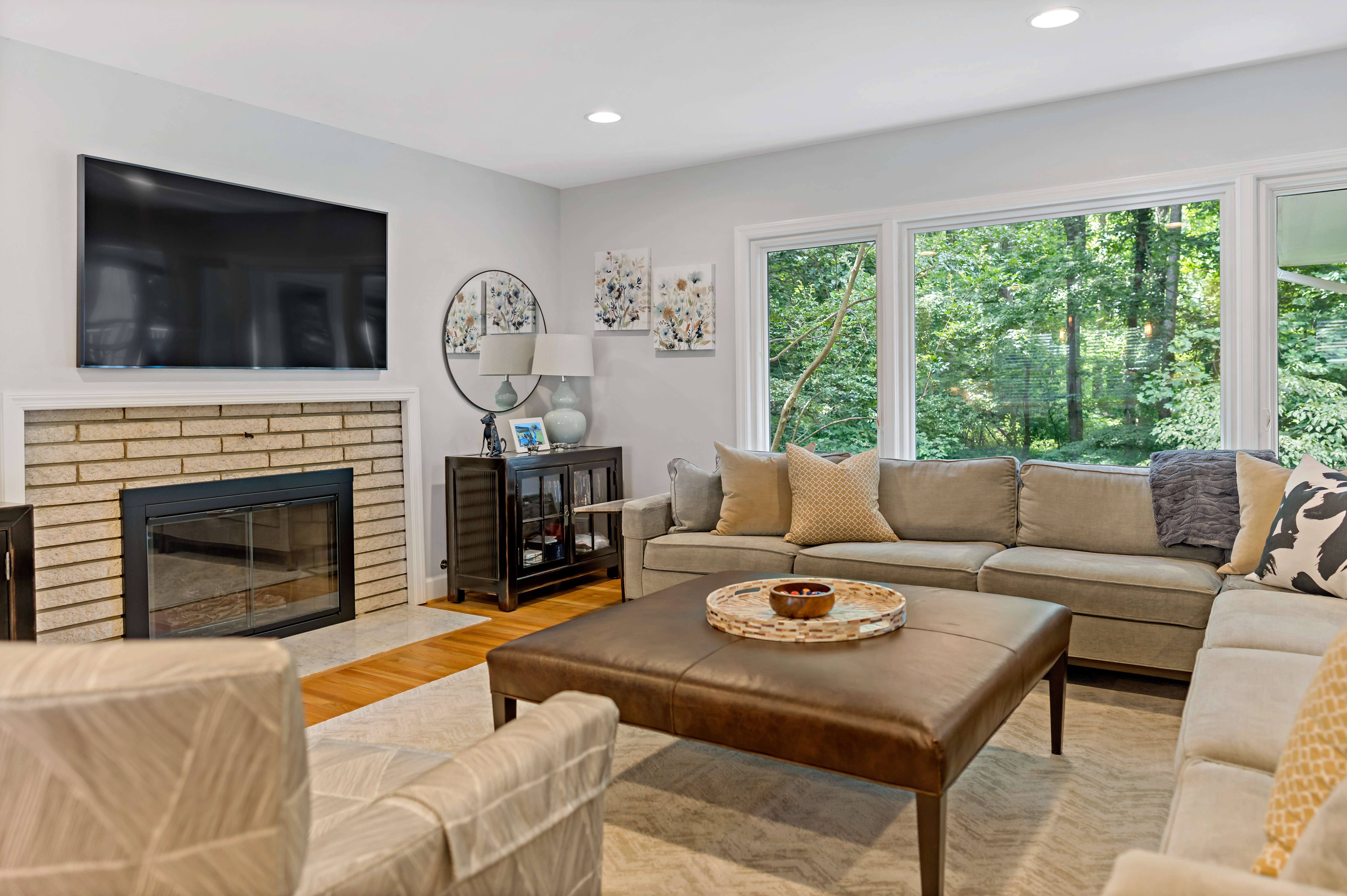 Living room with brick fireplace and mounted tv