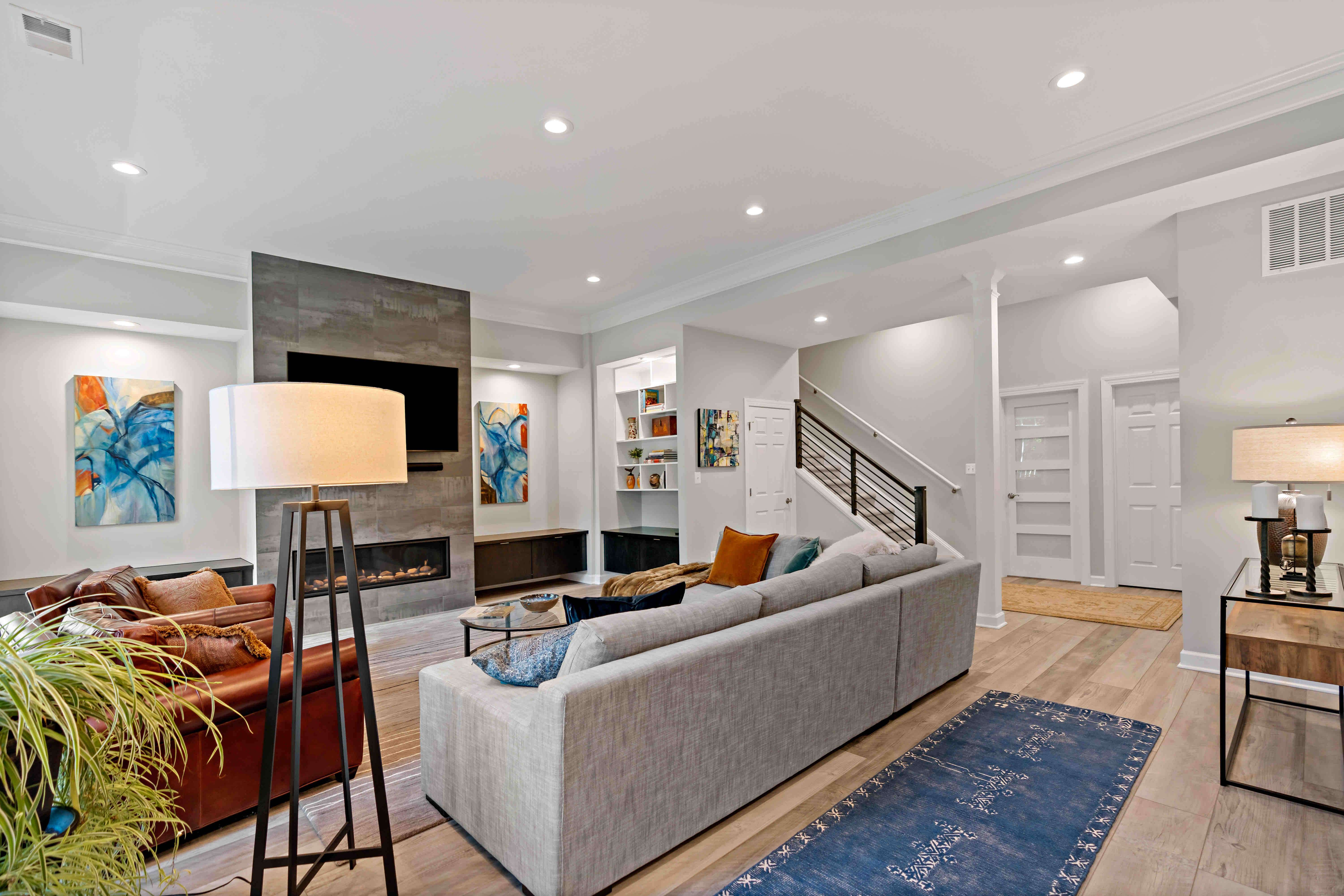 Entertainment space in basement with couches and electric fireplace