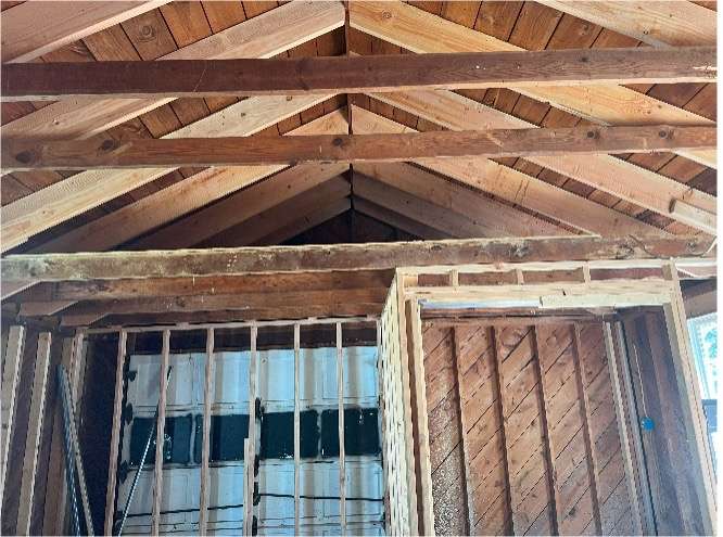Wood beam foundational support inside garage