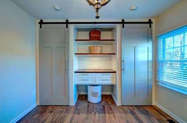 Two grey sliding barn doors in Herndon mudroom